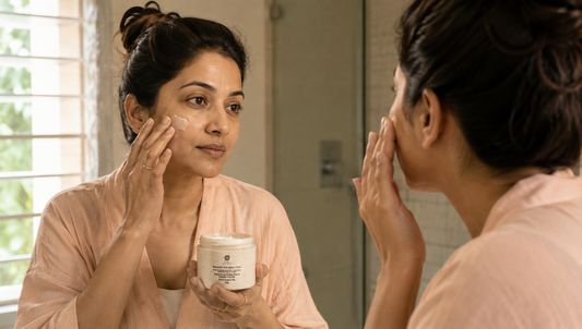 Woman in her thirties applying anti-ageing cream to her face in natural daylight